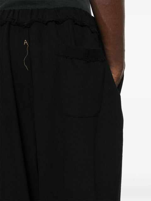 Pantalone con pieghe