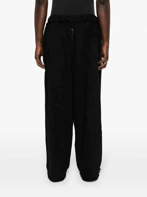 Pantalone con pieghe